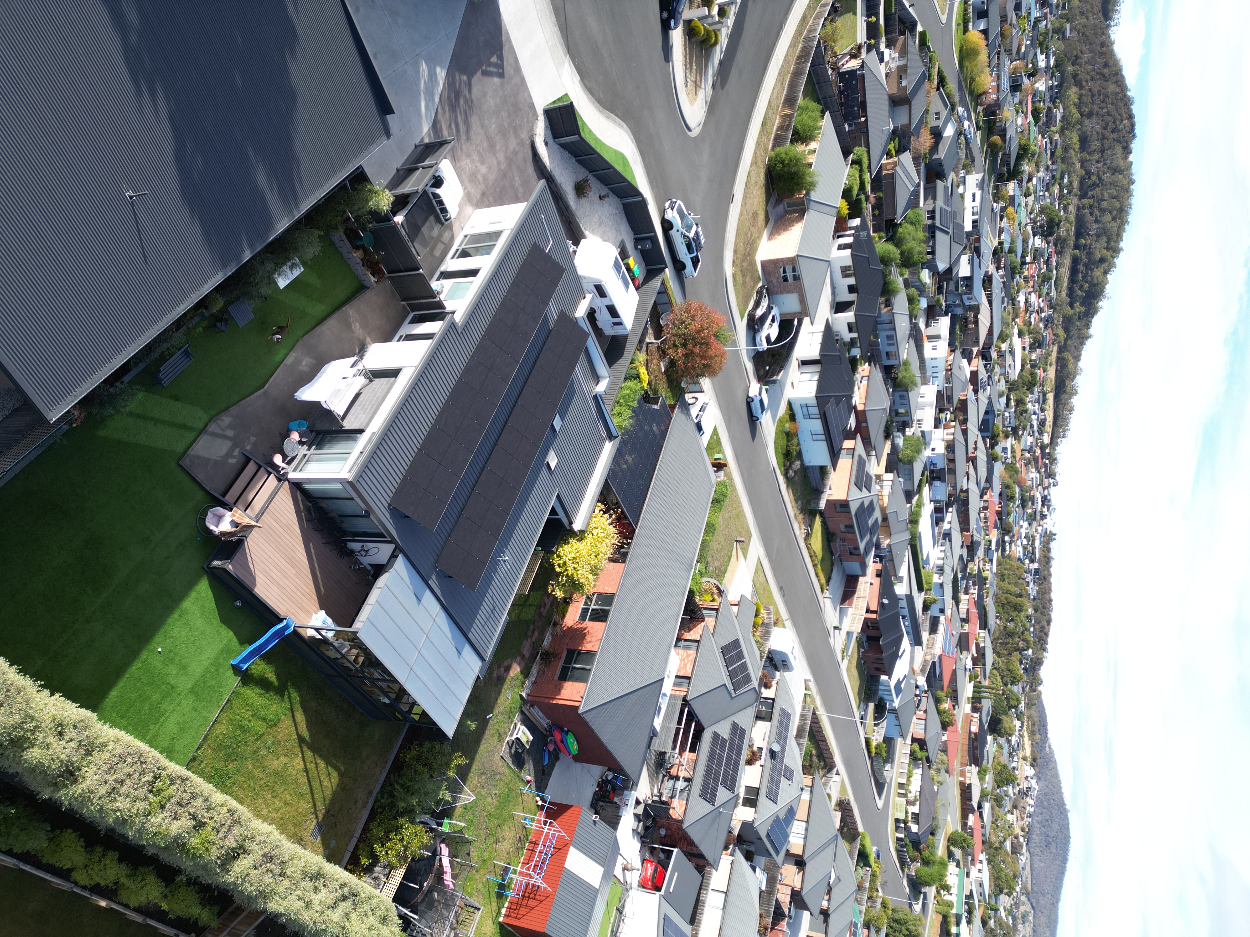 Aerial view of Hobart suburb with solar panels on rooftops